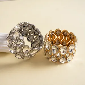 Detail of gold and silver elastic bracelets with teardrop-shaped clear crystals