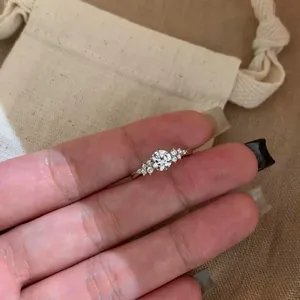 Detailed view of a French style silver ring featuring a brilliant round zircon stone