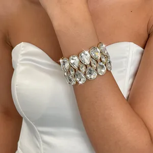 Detail of a sparkling double-layer teardrop rhinestone elastic bracelet on wrist.