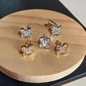 Macro view of sparkling zircon star and butterfly ear cuffs for non-pierced ears.