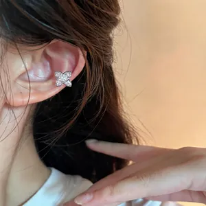 Detailed close-up view of a sparkling butterfly-shaped zircon ear cuff on an ear