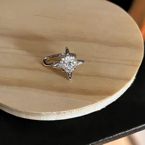 Detailed macro view of a sparkling zircon north star ear cuff with a silver finish