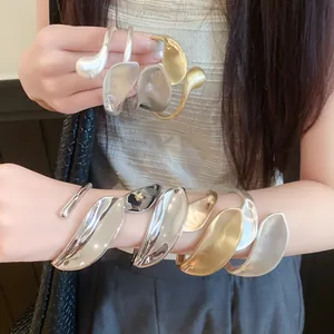 Macro shot of twisted irregular metallic bracelets with matte and glossy finishes