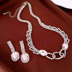 Elegant rhinestone jewelry set featuring pale pink oval pendants on necklace and earrings