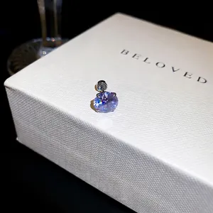 Exquisite sparkling purple cubic zirconia screw-back stud earring presented on a white gift box