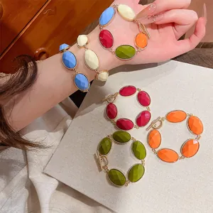 Detail of vibrant dopamine style resin oval bracelets with gold-tone metal frames