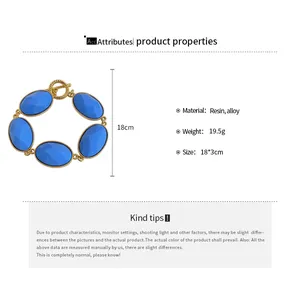 Macro view of blue resin oval bracelet with gold alloy frame and product material specifications.