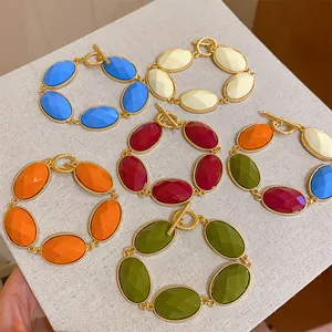 Detailed view of colorful oval resin bracelets with vintage gold-tone metal chains.