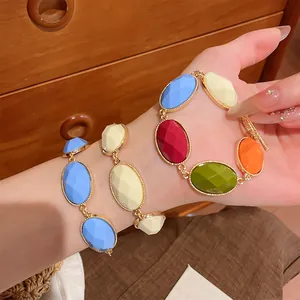 Detailed view of colorful dopamine-style resin oval bracelets with vintage gold settings