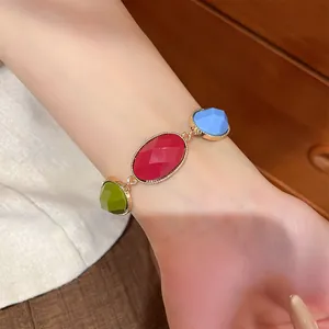 Detailed macro view of vibrant multicolored resin stone bracelet on woman's wrist