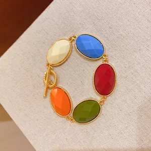 Colorful oval resin stone bracelet with gold-toned metal chain and toggle clasp