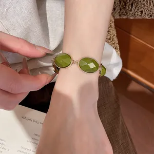 Detailed shot of a vintage green resin oval bracelet with gold-toned metal links