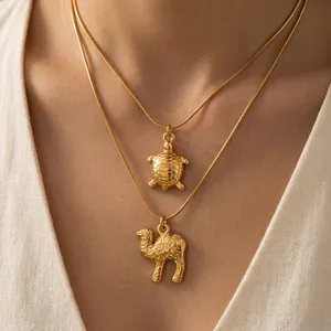 18K gold plated stainless steel necklace set with turtle and camel pendants on model
