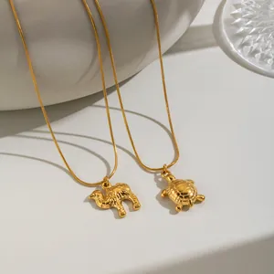Detailed macro view of 18K gold plated turtle and camel pendant jewelry necklaces
