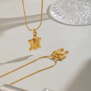 Detailed macro view of the 18K gold-plated turtle pendant on an elegant snake chain