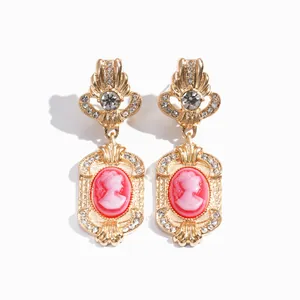 Elegant vintage palace style earrings with pink resin cameo and sparkling rhinestones