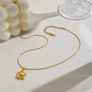 Gold stainless steel necklace featuring a detailed turtle pendant on a snake chain.