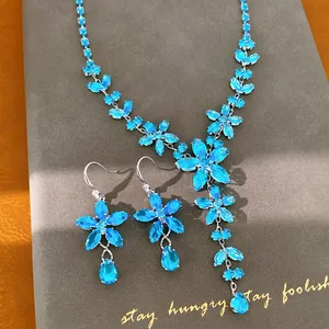 Detailansicht eines blauen Zirkon-Blumen-Schmucksets mit Halskette und Ohrringen