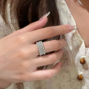 Macro detail showing the exquisite pearls and openwork design of a 18k gold plated ring.