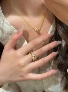 Detailed view of an exquisite 18k gold plated open ring with zircon and pearls