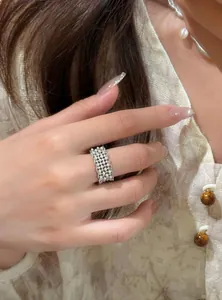 Elegant 18k gold plated lace ring with sparkling cubic zirconia on index finger.