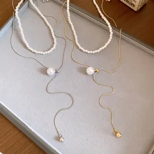 Élégant ensemble de deux colliers en perles de style français sur plateau à bijoux