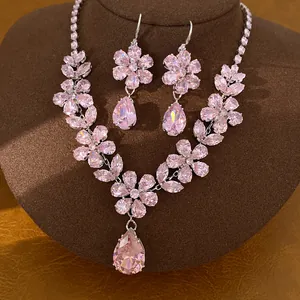 Close-up of pink zircon flower and teardrop jewelry set on brown display bust