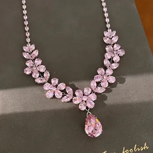 Detailed close-up of pink zircon flower necklace with a large teardrop pendant.