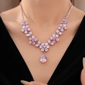 Detailed macro view of sweet zircon flower necklace with pink water drop pendant jewelry.