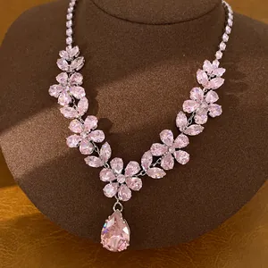 Elegant pink zircon necklace featuring crystal flowers and a large teardrop pendant detail
