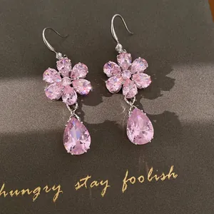 Close-up detail of elegant pink zircon flower teardrop earrings with silver hooks