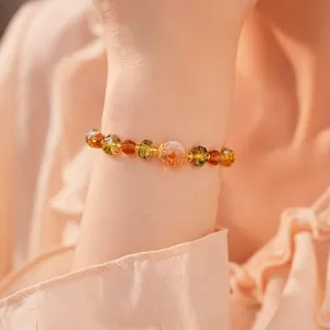 Elegant handmade glass beaded bracelet featuring amber and green faceted crystals