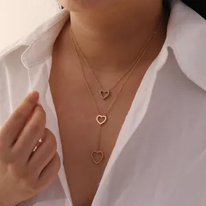 Close-up of a gold stainless steel heart lariat necklace with sparkling rhinestones