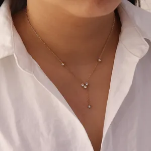 Detailed close-up of a gold stainless steel Y-shaped necklace with white zircons