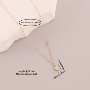 Close-up showing the white zircon heart pendant on a golden stainless steel chain