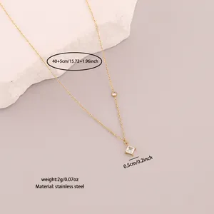 Detailed view of gold stainless steel Y-shaped necklace with white diamond pendant specs