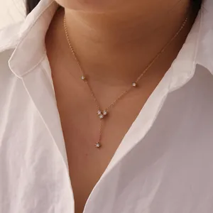 Close-up of gold stainless steel Y-shaped necklace with white zircon pendant on model