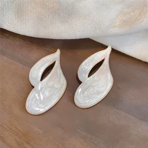 Detailed view of elegant white pearlescent drip oil leaf-shaped silver needle stud earrings