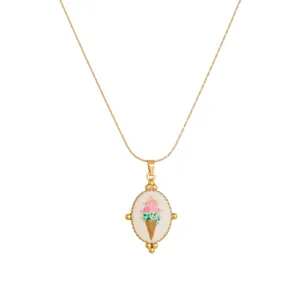 Detailed view of a gold-plated oval enamel necklace featuring a colorful ice cream cone