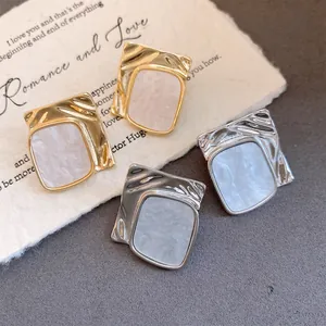 Elegant square wrinkled metal earrings with white marble acetate inlay in gold and silver