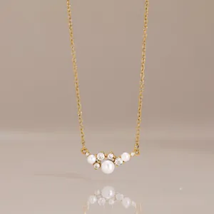Close-up detail of 18k gold-plated stainless steel smile necklace with pearls and zircons
