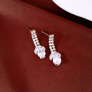 Close-up of elegant silver-tone waterdrop earrings with sparkling clear zircons