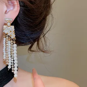 Gros plan de boucles d'oreilles pendantes avec perles et strass style palais français