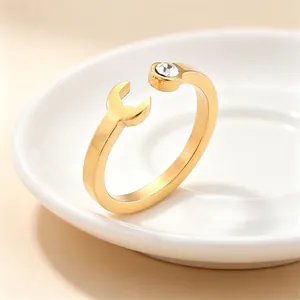 Macro view of creative gold wrench ring featuring a sparkling inset crystal detail