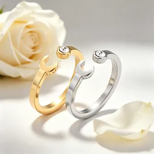 Close-up of creative wrench-shaped stainless steel rings with inset crystal stones