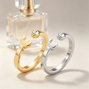 Macro detail of creative wrench-shaped stainless steel rings with small crystal stone accents