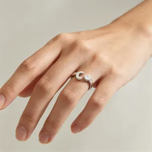Close-up of creative wrench-shaped stainless steel ring with crystal accent