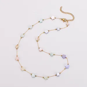 Close-up of colorful shell flower charms on a delicate gold stainless steel necklace