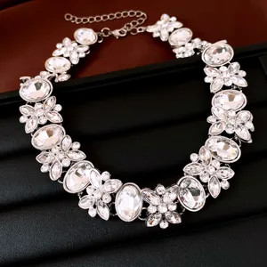 Detailed close-up of a luxury crystal flower statement necklace on a black background