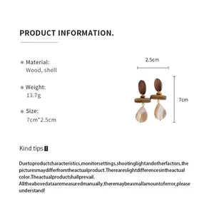 Detailed view of wood and shell water drop earrings with product size information